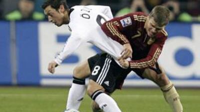 Russia's Igor Denisov, right, challenges Germany's Mesut Ozil during their match at Luzhniki stadium in Moscow.