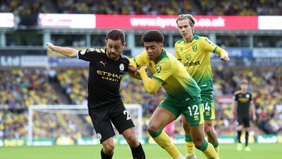 Manchester City's Bernardo Silva and Norwich City's Jamal Lewis battle for the ball. AP