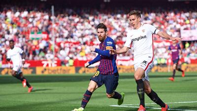 Lionel Messi tussles with Marko Rog of Sevilla. Getty