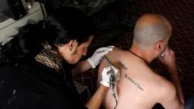 Mohammed Atshan tattoos Nizar a filmmaker and translator for western journalists.