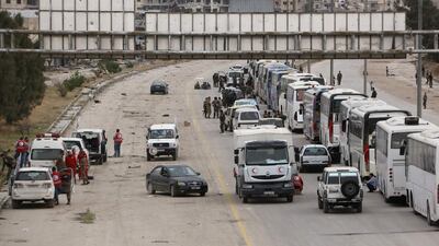 Hundreds of fighters and civilians from Harasta in Syria’s Eastern Ghouta sit on busses on March 23, 2018 after a deal was struck with the opposition to evacuate a second pocket of the rebel enclave on the outskirts of Damascus. AFP