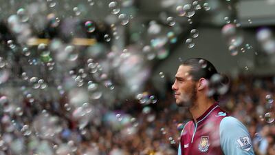 West Ham United's English striker Andy Carroll makes his debut through a cloud of bubbles at Upton Park. Andrew Cowie/AFP