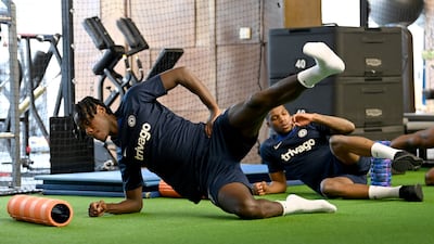 Chelsea defender Trevoh Chalobah stretched during a warm up in the gym before a training session at Chelsea training ground.