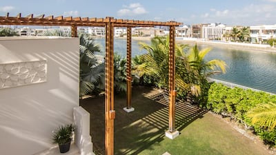 The Emirates Hills property's grassed terrace areas, which overlooks a communal lake, is ideal for entertaining guests. Courtesy Luxhabitat