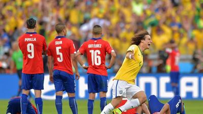 David Luiz of Brazil celebrates after defeating Chile in the penalty shootout on Saturday during their 2014 World Cup last-16 match in Belo Horizonte, Brazil. Buda Mendes / Getty Images
