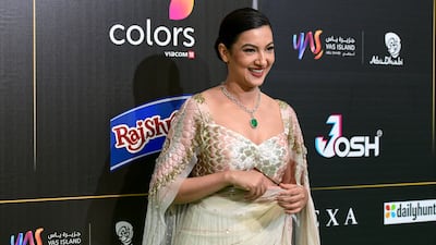 Gauahar Khan wearing a cream sari with metallic detail. Khushnum Bhandari / The National