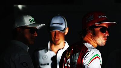 Fernando Alonso, right, has struggled in his new Ferrari F1 car. Clive Mason / Getty Images