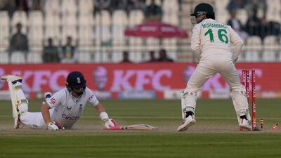 England's Ollie Pope, left is run out by Pakistan' wicketkeeper Muhammad Rizwan for four. AP