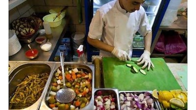 A cook prepares Lebanese delicacies at one of the branches of the Automatic Restaurant and Cafeteria near Hamdan Street in Abu Dhabi. Silvia Razgova / The National