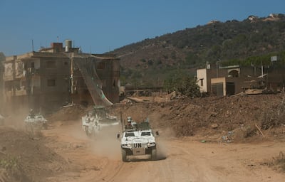 A Unifil convoy passes an Israeli military base in southern Lebanon. Reuters