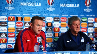Wayne Rooney, left, and Roy Hodgson, right, have asked England fans to behave to avoid the possibility of being thrown out of Euro 2016. AFP