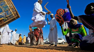 Displaced Sudanese dance during a visit by Sudan's prime minister in El-Fasher, the capital of the North Darfur state. AFP