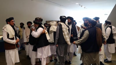 Members of the Taliban delegation gather ahead of an agreement signing between them and US officials in Doha, Qatar. Reuters