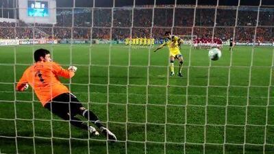 Apoel's Nuno Morais scores against Lyon's goalkeeper Hugo Lloris during the penalty shootout in last years Champions League.