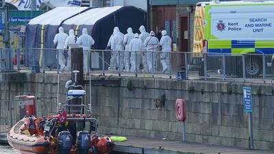 Forensics officers gather at the Port of Dover, where a body bag was brought ashore. PA