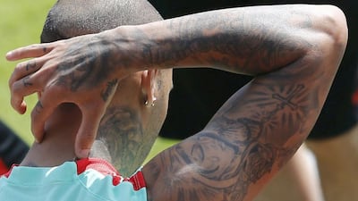 Tatoos are pictured on the arm of Portugal’s player Ricardo Quaresma during training. REUTERS/Regis Duvignau