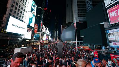 Screens in Times Square are black during a power outage in New York. AP