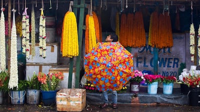 A customer shops for garlands in Gauhati, India. Anupam Nath / AP Photo