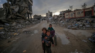 Palestinian children play near temporary shelters where hundreds of displaced families live, in Al Tuffah, east of Gaza city. EPA