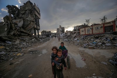 Palestinian children play near their families' shelters, among destroyed buildings, in Al Tuffah. EPA