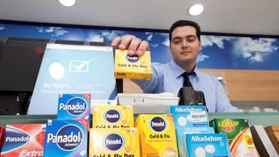 Pharmacist Ahmad Samir grabs a box of Panadol at Aster pharmacy in Dubai. UAE health experts have warned that misuse of painkillers like paracetamol is leading to liver damage and even death.