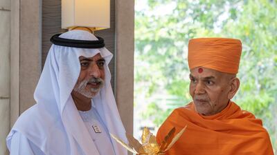 Mahant Swami Maharaj presents a golden amrut kalash (vessel of immortality) to Sheikh Nahyan.