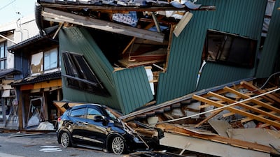 A damaged car stands near a collapsed house, following an earthquake, in Nanao, Ishikawa prefecture. Reuters