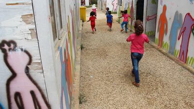Syrian refugee children wander between classrooms at the Al Ihsan Academic Centre in Minyara, Lebanon. With a computer lab, a music room, a library, cooked lunches and even a soccer coach, the school is a bit of an anomaly in a country where about half of all Syrian children have no access to education. Josh Wood for The National.
