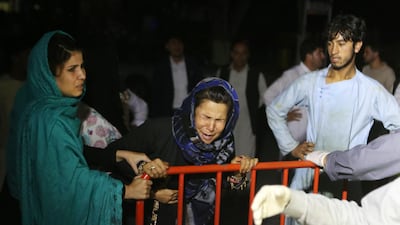 An Afghan woman who has lost his husband and two sons grieves at the door of the hospital, after a suicide attacker detonated his explosive vest among a wedding ceremony in a wedding hall in Kabul. EPA