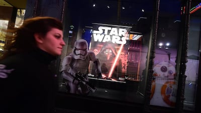 A woman rushes past a store selling Star Wars merchandise along Hollywood Boulevard for the premiere of the latest Star Wars film, The Force Awakens in Hollywood, California. Frederic J Brown / AFP photo