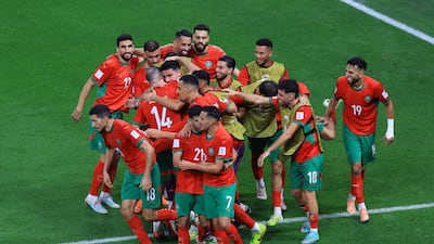 Aschraf El Mahdioui celebrates scoring Morocco's second goal with teammates. Reuters