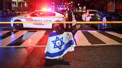 A man draped in the Israeli flag outside the Capital Jewish Museum following a shooting that left two people dead in Washington, DC. AFP