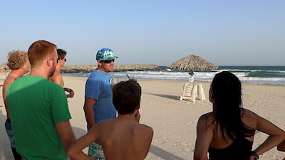 Carl de Villiers briefs students at his surfing school at Al Khan beach in Sharjah. Satish Kumar / The National