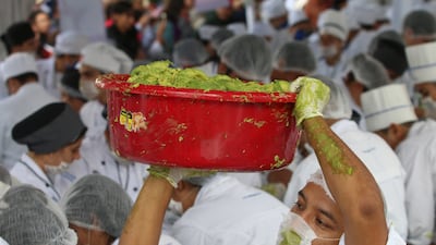 A volunteer from a culinary school carries a bowl of guacamole as he attempts with others to set a new Guinness World Record for the largest serving of guacamole in Concepcion de Buenos Aires, Jalisco, Mexico. Fernando Carranza / Reuters