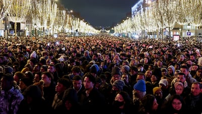 People gather on the Champs Elysees avenue during the New Year's Eve celebrations in Paris, France. Reuters