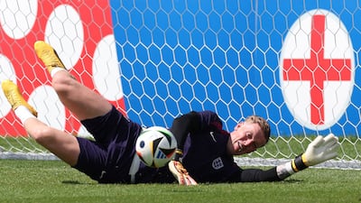 England goalkeeper Jordan Pickford makes a save during training. AFP