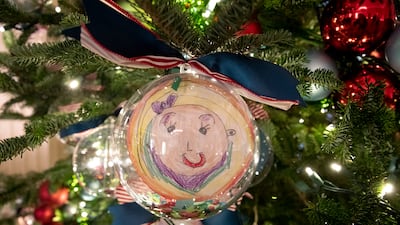 Ornaments depicting self-portraits made by pupils of the recipients of the 2021 Teacher of the Year award decorate a Christmas tree in the State Dining Room. EPA
