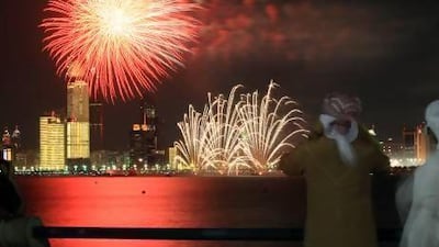 People watch a fireworks display on Abu Dhabi Corniche. Officials have warned people against buying illegal fireworks and advised families to attend organised displays in the run up to Eid Al-Fitr. Ravindranath K / The National