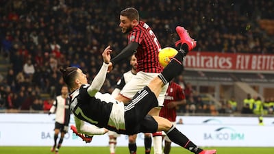 Cristiano Ronaldo's overhead kick strikes the arm of Milan's Davide Calabria to earn Juventus a controversial late penalty at the San Siro on Thursday. Getty