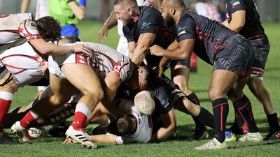 Abu Dhabi Harlequins and Dubai Exiles players battle for the ball during the UAE Premiership final.