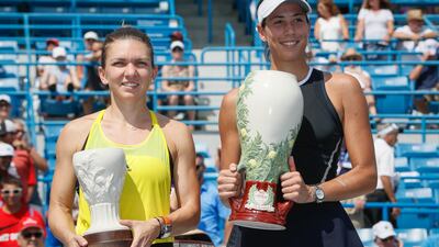 Spain's Garbine Muguruza, right, holds the Rookwood Cup after defeating Romania's Simona Halep, left, during the women's singles final at the Cincinnati Open, Sunday, August 20, 2017, in Mason, Ohio. Muguruza won 6-1, 6-0. John Minchillo / AP Photo