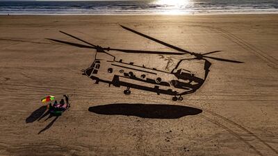 A 75-metre piece of sand art depicting a military Chinook helicopter was unveiled Saunton Sands beach in Devon on Thursday, as part of the Defence Infrastructure Organisation 'Respect the Range' campaign, warning holidaymakers and locals to check military firing and training times. PA
