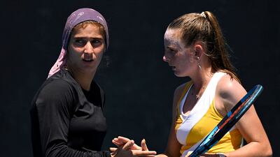 Meshkatolzahra Safi of Iran, left, and Nahia Berecoechea of France compete during a girls doubles match at the Australian Open. AFP