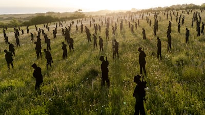 Dawn breaks over the life-sized steel silhouettes of the Standing with Giants installation at the British Normandy Memorial in Ver-sur-Mer, north-west France. PA