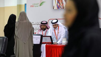 Bahraini women register to vote at a polling station on the island of Muharraq, north of the capital Manama, during parliamentary elections, on November 12, 2022. - More than 330 candidates, including a record 73 women, are competing to join the 40-seat council of representatives, the lower house of parliament that advises King Hamad bin Isa Al-Khalifa, who has ruled since his father died in March 1999. (Photo by AFP)