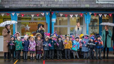 Staff and pupils from Holy Trinity Church of England First School await their arrival. Getty Images