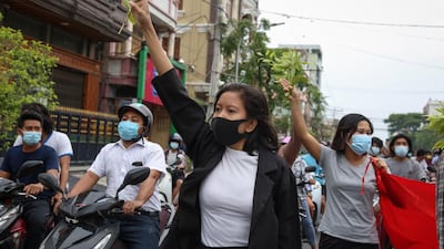 A demonstrator gives a three-finger salute during an anti-military coup protest in Mandalay, Myanmar. EPA