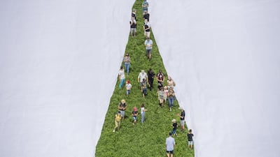 An inside leg view of the giant trousers being unfurled. Xwendekar Kelesh, who fled Syria to Switzerland 11 years ago, said the giant trousers are intended to draw attention to plastic pollution. EPA