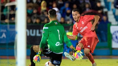 Real Madrid's Spanish midfielder Lucas Vazquez shoots in front of UD Melilla's Spanish goalkeeper Dani Barrio. AFP