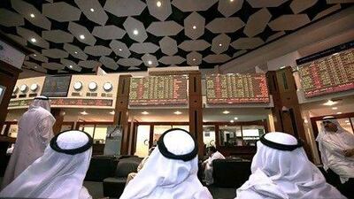 Traders on the floor of the Dubai Financial Market stock exchange. Nicole Hill / The National